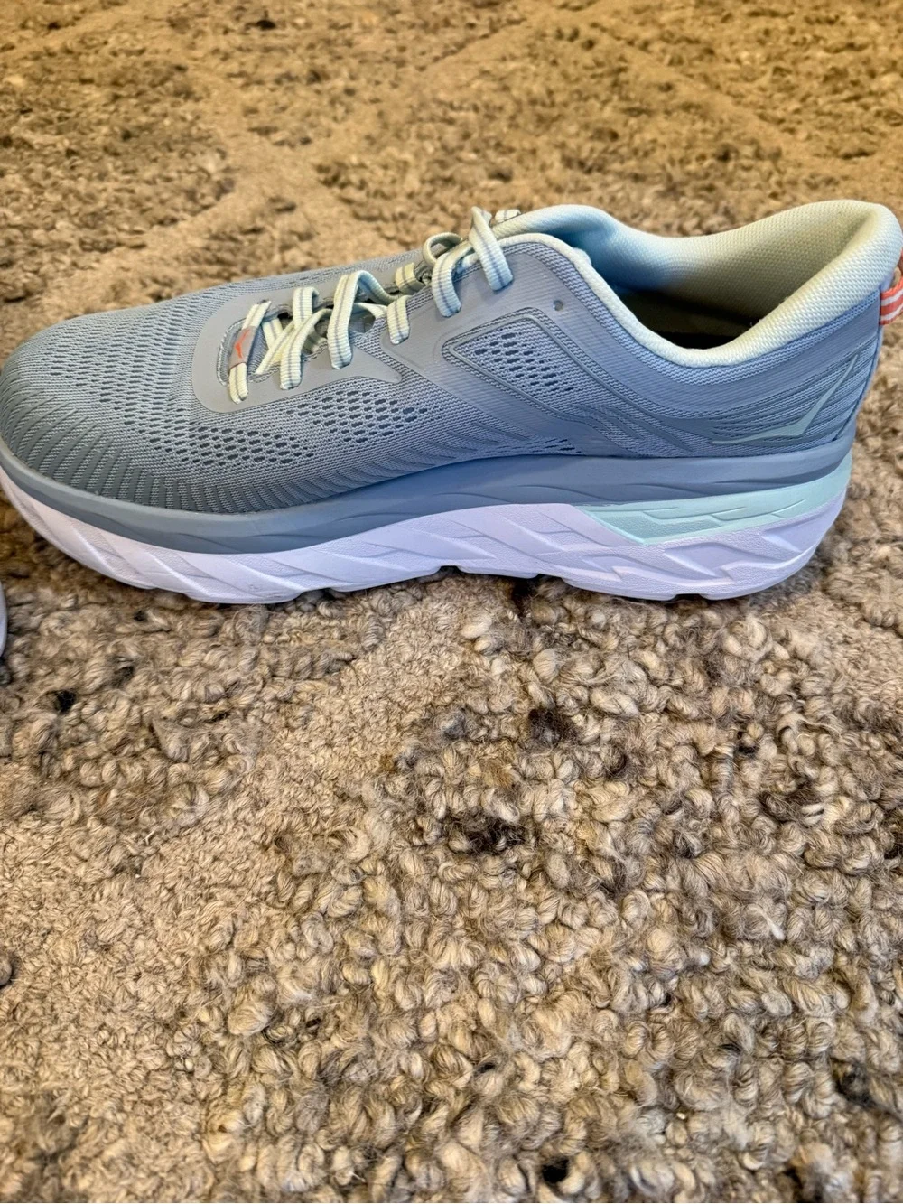 Hoka Pale Gray Running Shoes with orange Accents